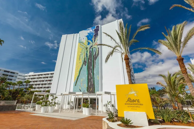 Abora Buenaventura entrance with a palm-tree mosaic on the façade